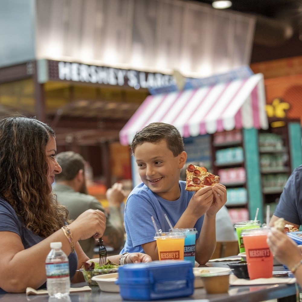 Boy enjoying pizza at Hershey's Chocolate World.