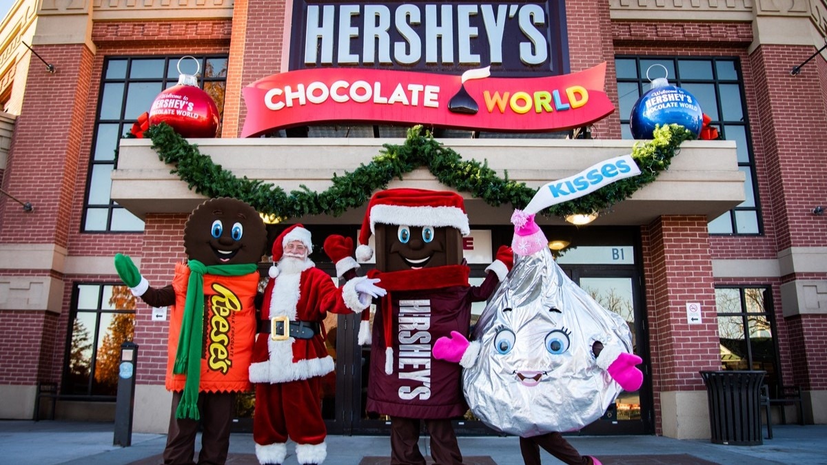 Characters and Santa in front of HERSHEY'S CHOCOLATE WORLD