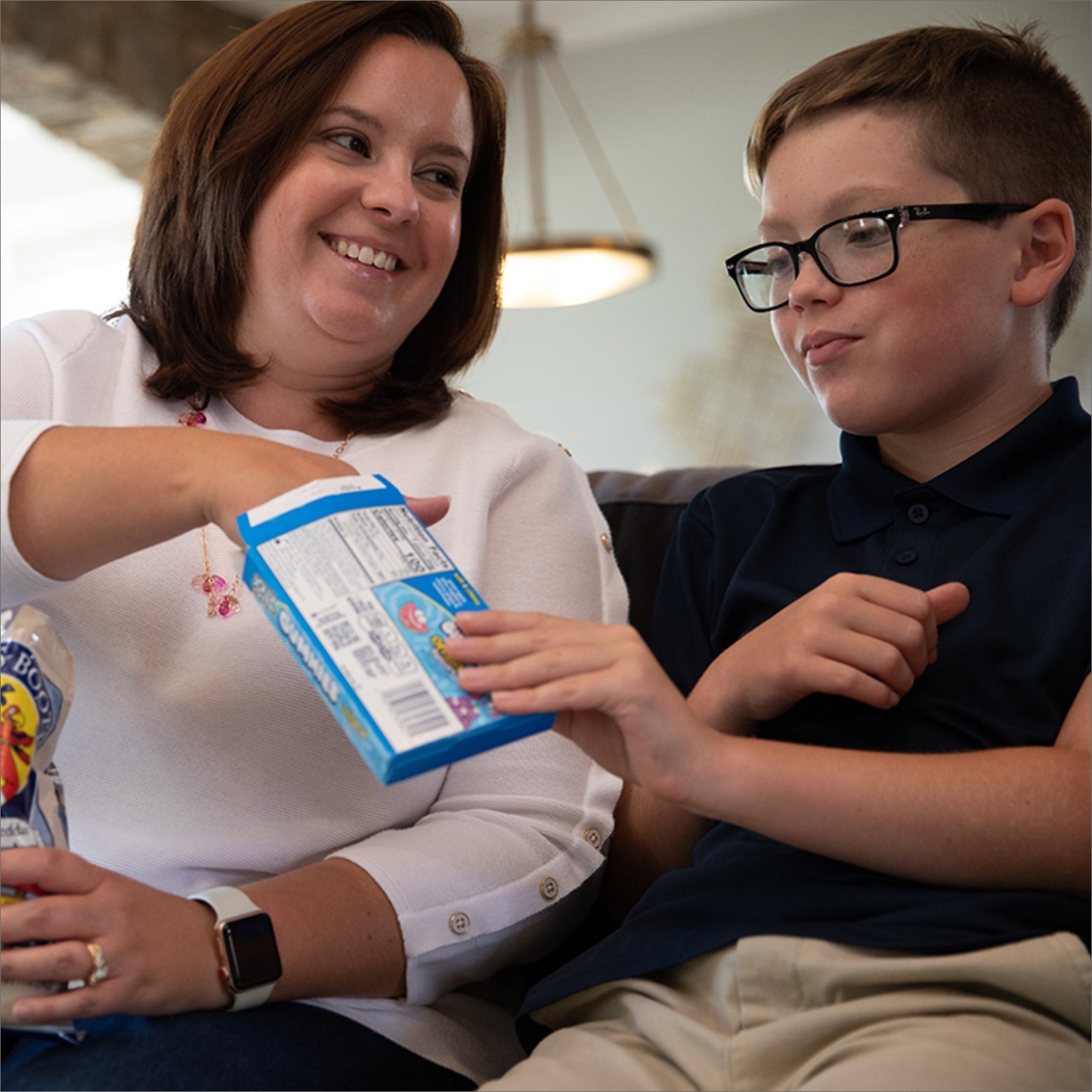 Woman and little boy sharing a box of candy