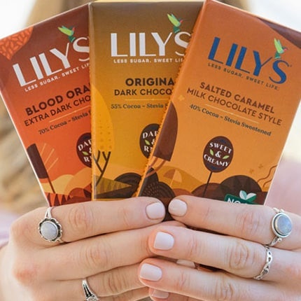 Hands holding three Lily's bars