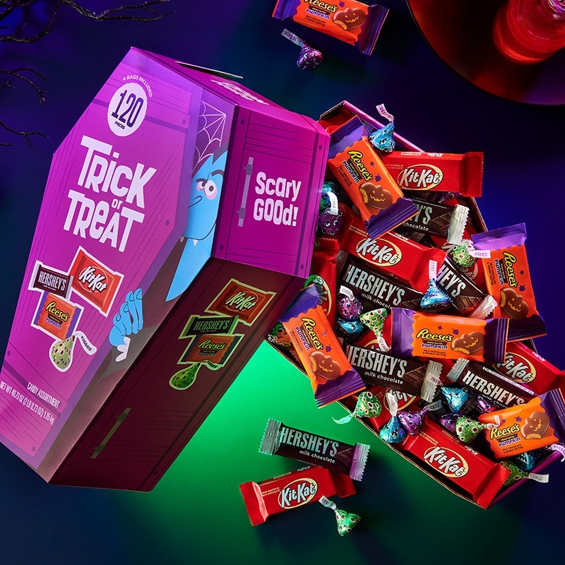 A Trick or Treat box overflowing with individually wrapped candy