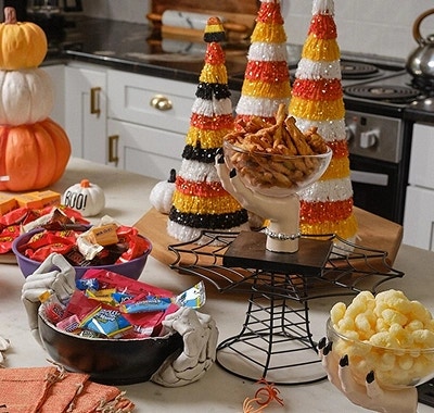 Candy corn trees and treats arranged on a kitchen counter