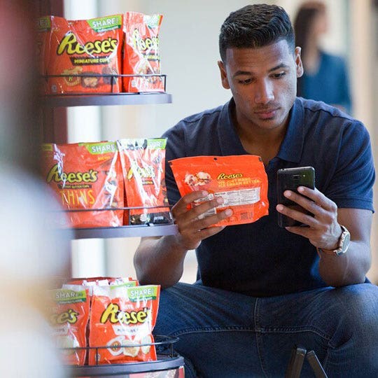 Man looking at Reese's Package