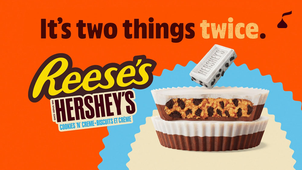 Reese’s Hershey’s Cookies ‘N Crème cups cut open to show the peanut butter and cookie filling beside the tagline “It’s two things twice.”