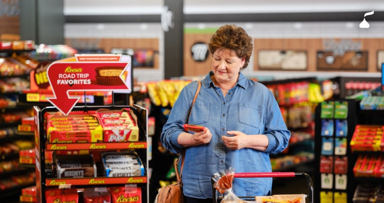 Woman looking at candy bar while shopping