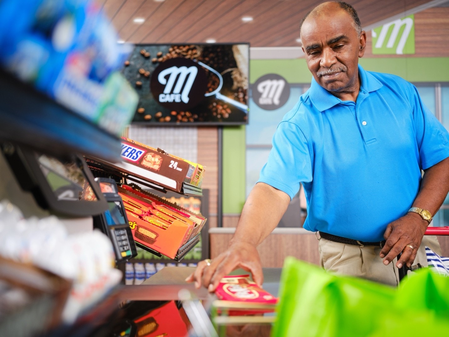 a man checking out at a cash register