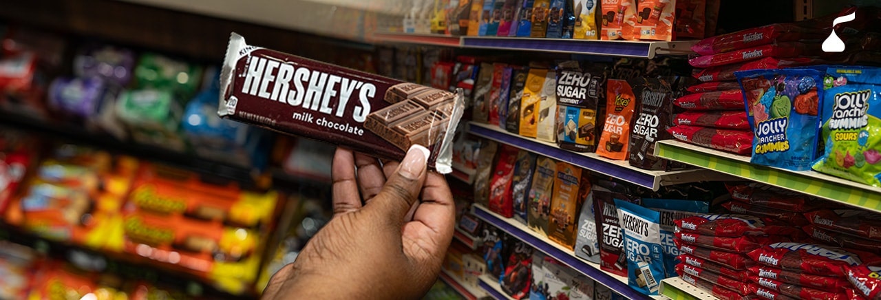Hand grabbing a Hershey's Chocolate Bar