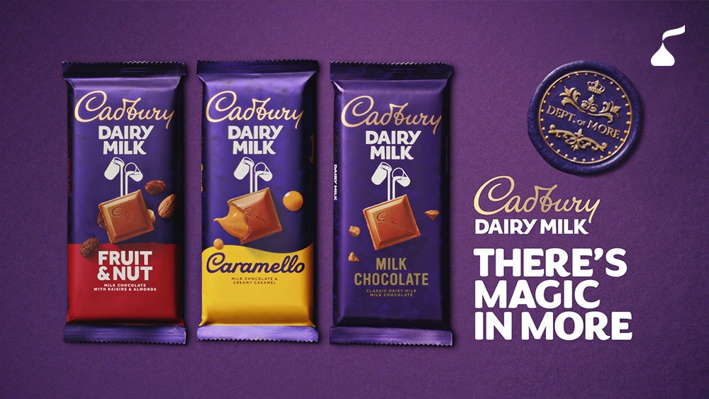 Cadbury Dairy Milk Fruit & Nut, Caramello and Milk Chocolate bars alongside the brand’s “There’s Magic in More” campaign artwork