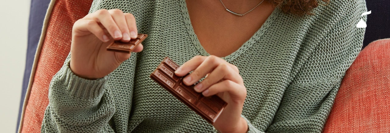 Person holding a piece of chocolate