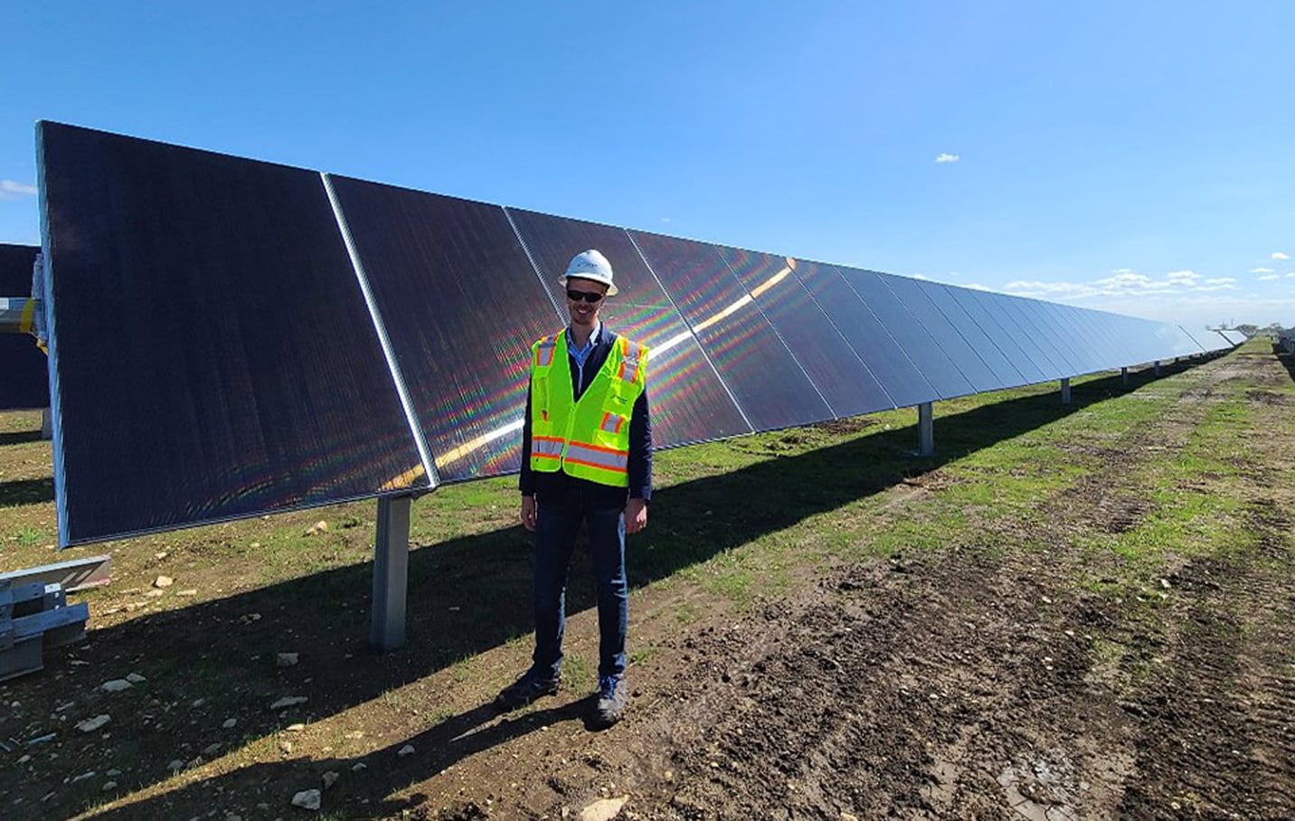 Person next to Solar Panels