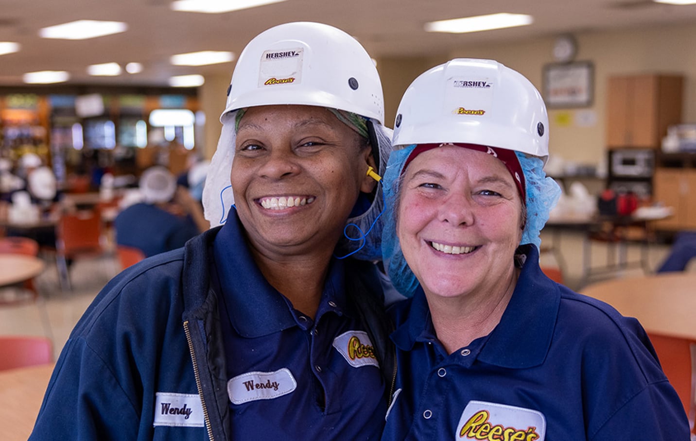 People in Hershey uniforms smiling