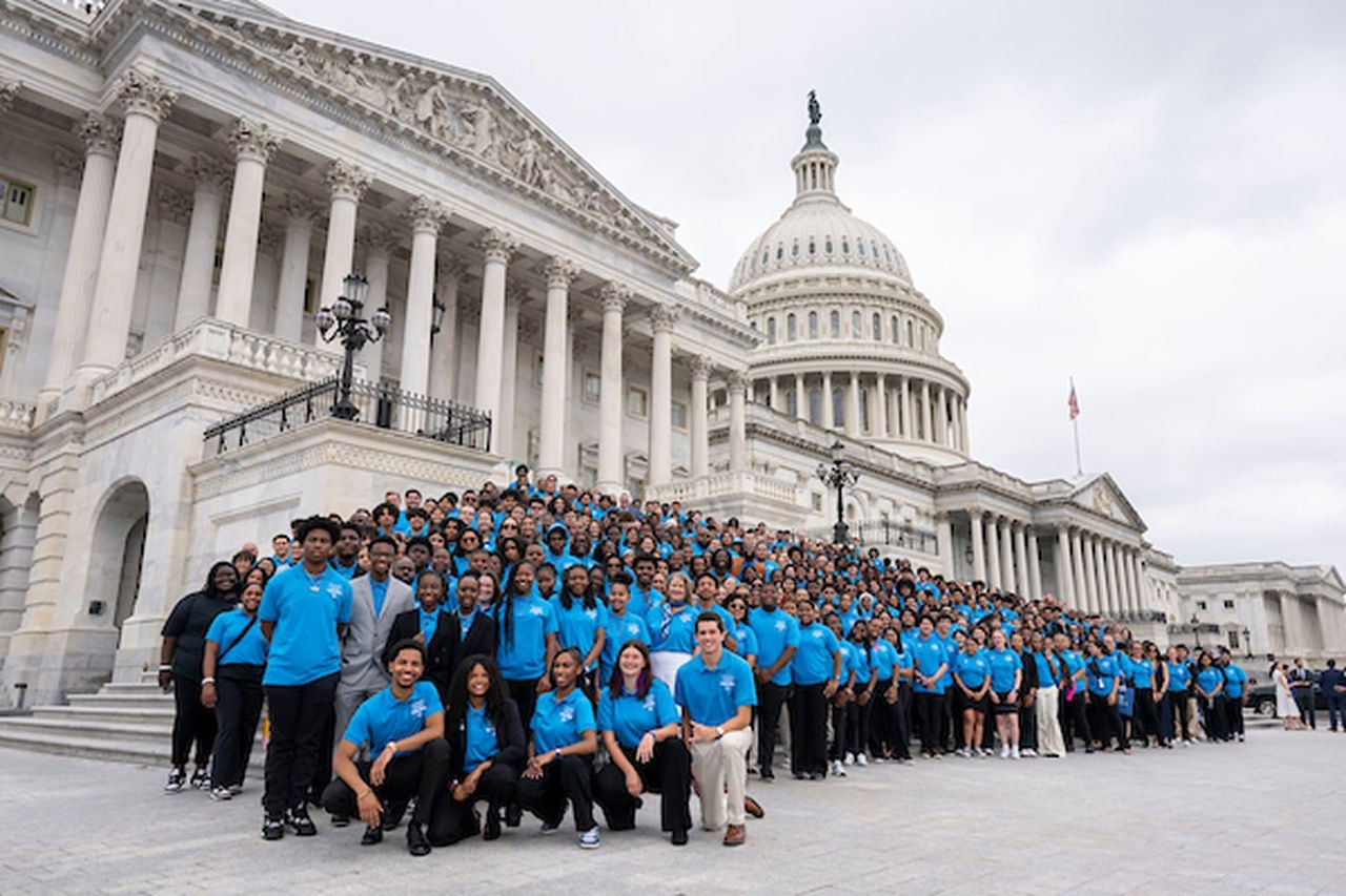 A class standing in front of the white house