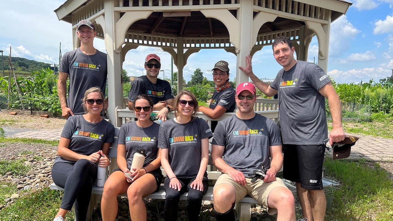 Volunteers sitting in a pavilion