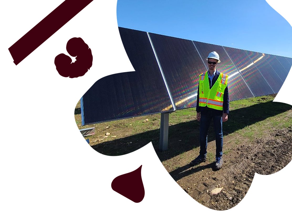 Person standing next to solar panels